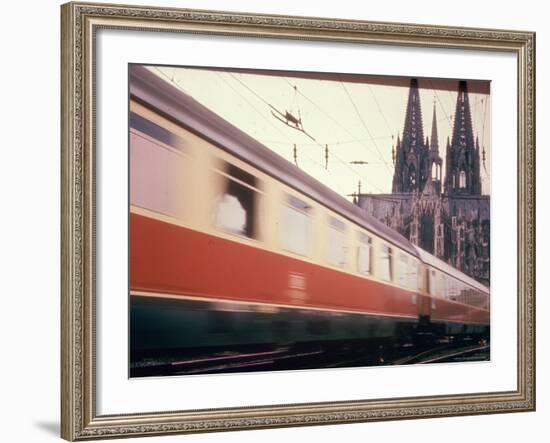 Eurailpass in Europe: Germany's Parsifal Express Speeding Past Cologne Cathedral-Carlo Bavagnoli-Framed Photographic Print