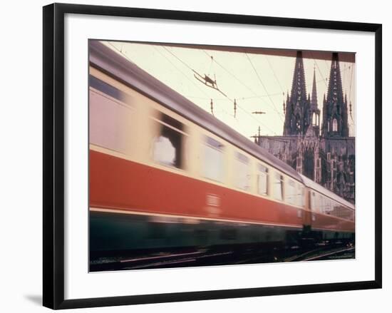 Eurailpass in Europe: Germany's Parsifal Express Speeding Past Cologne Cathedral-Carlo Bavagnoli-Framed Photographic Print