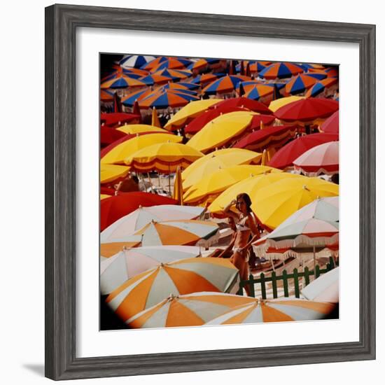 Europe Beach Scene Crowded with Colorful Umbrellas and a Bikini-Clad Young Woman-Ralph Crane-Framed Photographic Print