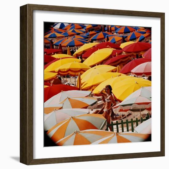 Europe Beach Scene Crowded with Colorful Umbrellas and a Bikini-Clad Young Woman-Ralph Crane-Framed Photographic Print