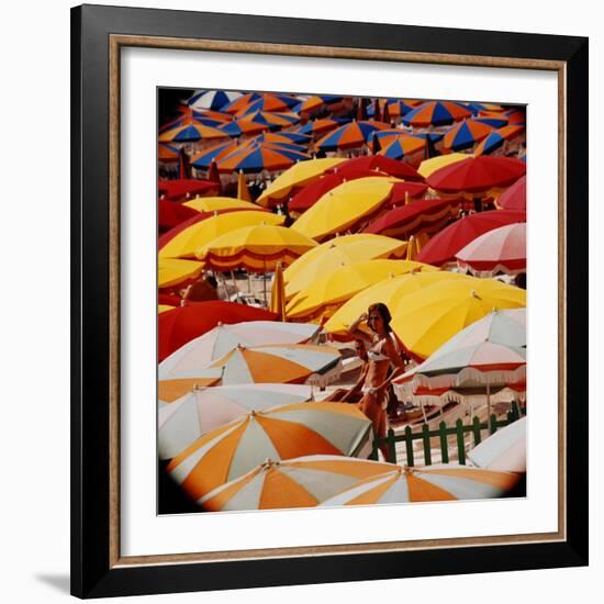 Europe Beach Scene Crowded with Colorful Umbrellas and a Bikini-Clad Young Woman-Ralph Crane-Framed Photographic Print
