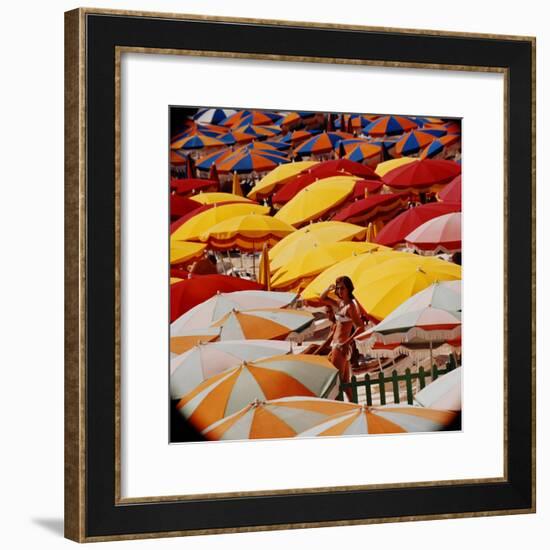 Europe Beach Scene Crowded with Colorful Umbrellas and a Bikini-Clad Young Woman-Ralph Crane-Framed Photographic Print