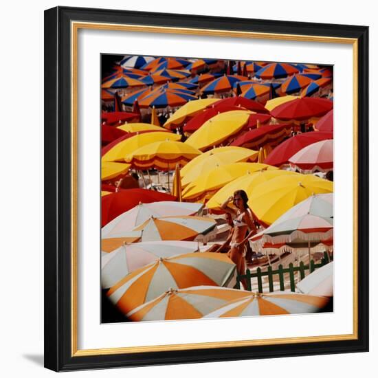 Europe Beach Scene Crowded with Colorful Umbrellas and a Bikini-Clad Young Woman-Ralph Crane-Framed Photographic Print