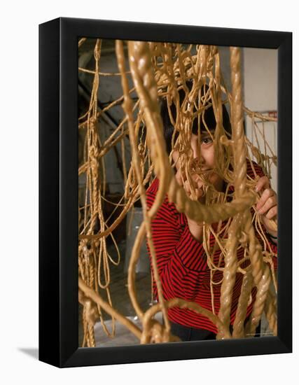 Eva Hesse Peering Through Her Sculpture of Rubber Dipped String and Rope-Henry Groskinsky-Framed Premier Image Canvas