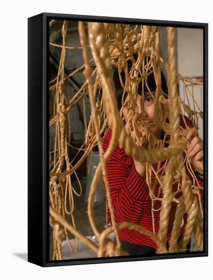 Eva Hesse Peering Through Her Sculpture of Rubber Dipped String and Rope-Henry Groskinsky-Framed Premier Image Canvas
