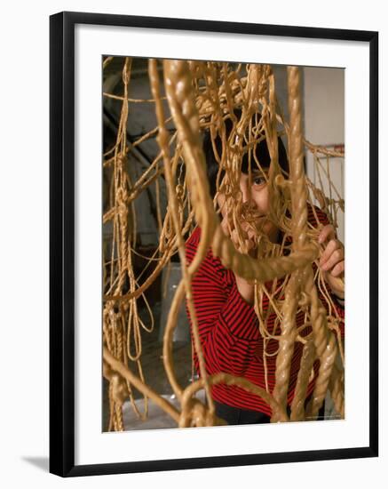 Eva Hesse Peering Through Her Sculpture of Rubber Dipped String and Rope-Henry Groskinsky-Framed Premium Photographic Print