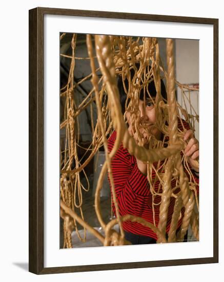 Eva Hesse Peering Through Her Sculpture of Rubber Dipped String and Rope-Henry Groskinsky-Framed Premium Photographic Print