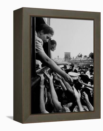 Eva Peron, Wife of Argentinean Presidential Candidate, Passing Out Campaign Buttons-Thomas D^ Mcavoy-Framed Premier Image Canvas