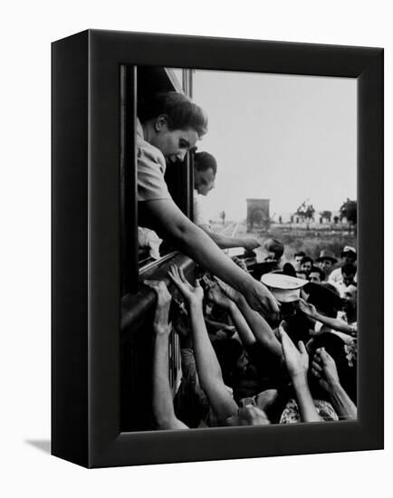 Eva Peron, Wife of Argentinean Presidential Candidate, Passing Out Campaign Buttons-Thomas D^ Mcavoy-Framed Premier Image Canvas