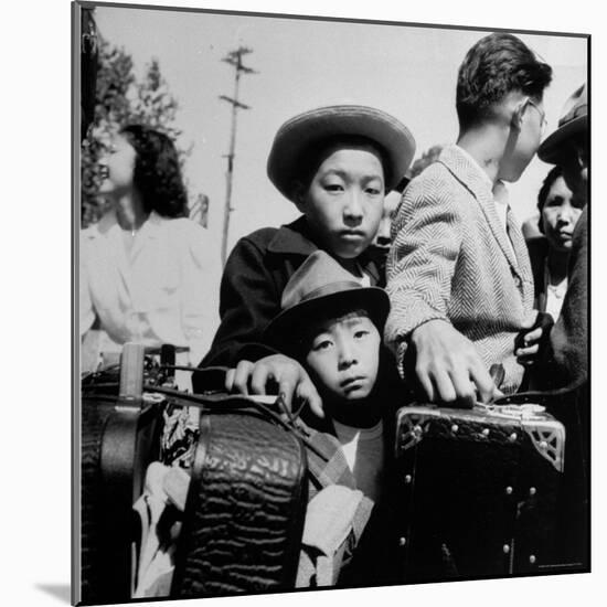Evacuees of Japan Awaiting Turn for Baggage Inspection upon Arrival at Assembly Center During WWII-Dorothea Lange-Mounted Photographic Print