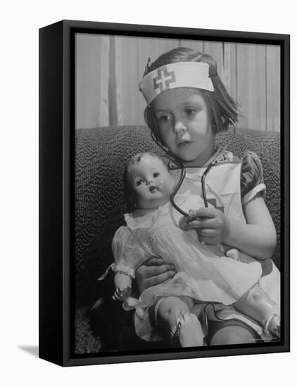 Evelyn Mott playing Nurse with doll as parents adjust children to abnormal conditions in wartime-Alfred Eisenstaedt-Framed Premier Image Canvas