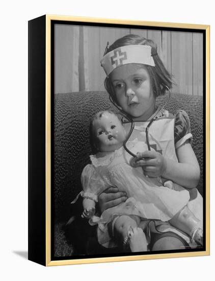 Evelyn Mott playing Nurse with doll as parents adjust children to abnormal conditions in wartime-Alfred Eisenstaedt-Framed Premier Image Canvas