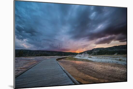 Evening Storm Clouds Gather Over A Boardwalk In Biscuit Basin, Yellowstone National Park-Bryan Jolley-Mounted Photographic Print