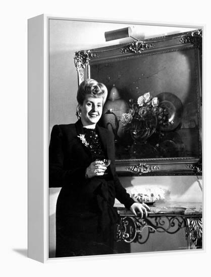 Evita Peron, Wife of Argentinean Presidential Candidate With. a Glass of Champagne in Her Apartment-Thomas D^ Mcavoy-Framed Premier Image Canvas