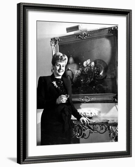 Evita Peron, Wife of Argentinean Presidential Candidate With. a Glass of Champagne in Her Apartment-Thomas D^ Mcavoy-Framed Premium Photographic Print
