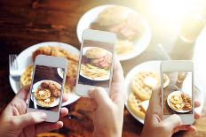 Friends Using Smartphones to Take Photos of Food with Instagram Style Filter-evren_photos-Framed Photographic Print