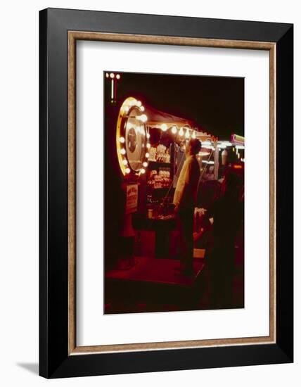 Fairgoer Stands on a 'Guess Your Weight' Carnival Game at the Iowa State Fair, 1955-John Dominis-Framed Photographic Print