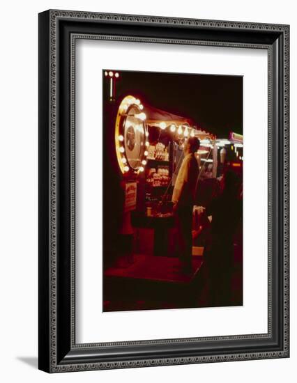 Fairgoer Stands on a 'Guess Your Weight' Carnival Game at the Iowa State Fair, 1955-John Dominis-Framed Photographic Print