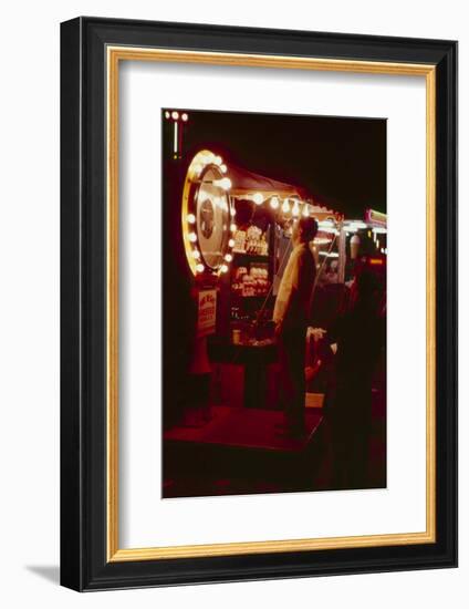 Fairgoer Stands on a 'Guess Your Weight' Carnival Game at the Iowa State Fair, 1955-John Dominis-Framed Photographic Print