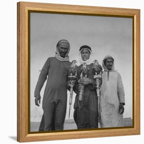 Falcon Trainers Holding onto Posts While their Birds Perch Atop Them-Bob Landry-Framed Premier Image Canvas