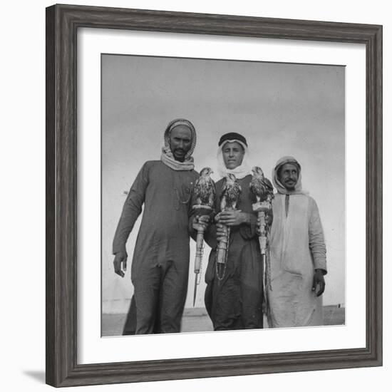 Falcon Trainers Holding onto Posts While their Birds Perch Atop Them-Bob Landry-Framed Photographic Print