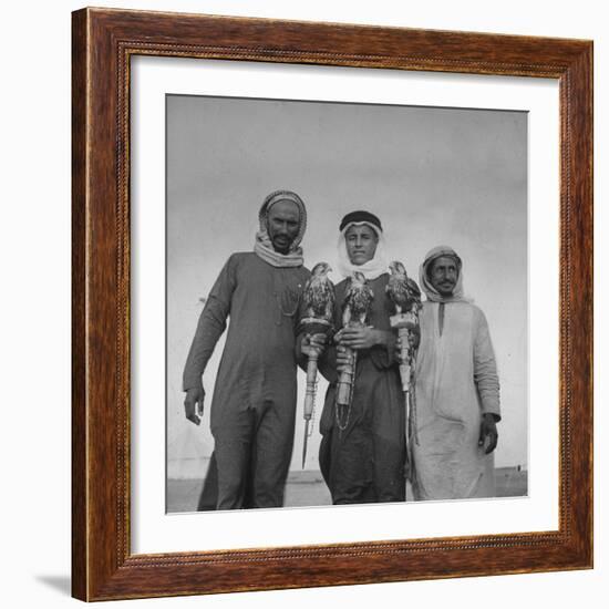 Falcon Trainers Holding onto Posts While their Birds Perch Atop Them-Bob Landry-Framed Photographic Print