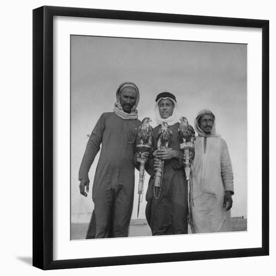 Falcon Trainers Holding onto Posts While their Birds Perch Atop Them-Bob Landry-Framed Photographic Print