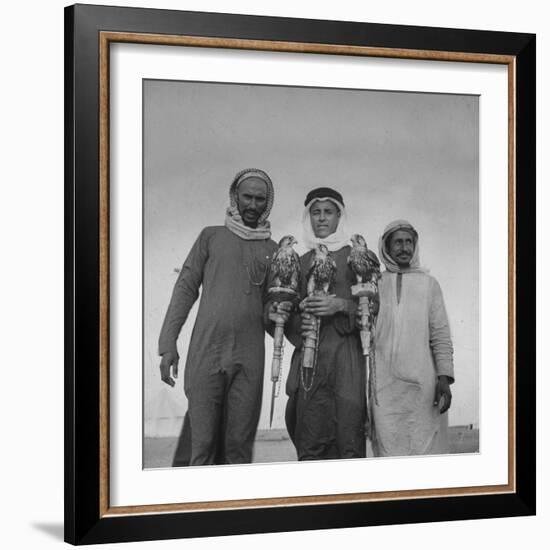 Falcon Trainers Holding onto Posts While their Birds Perch Atop Them-Bob Landry-Framed Photographic Print