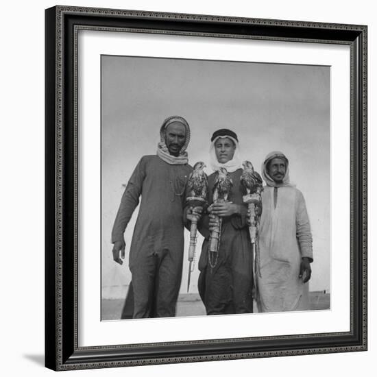 Falcon Trainers Holding onto Posts While their Birds Perch Atop Them-Bob Landry-Framed Photographic Print