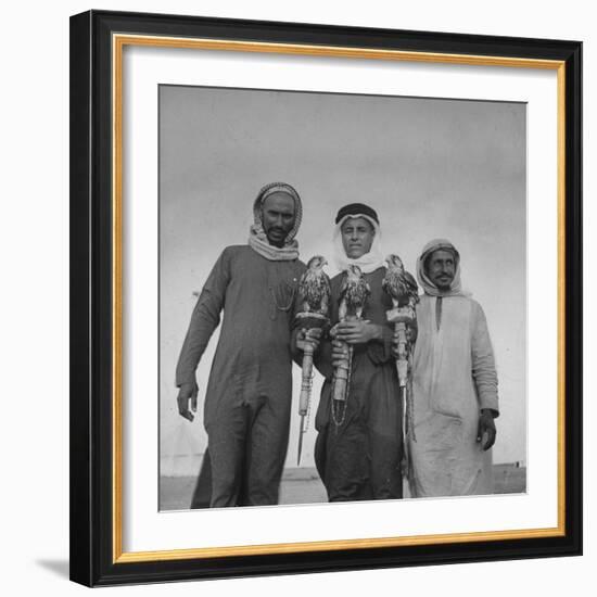 Falcon Trainers Holding onto Posts While their Birds Perch Atop Them-Bob Landry-Framed Photographic Print