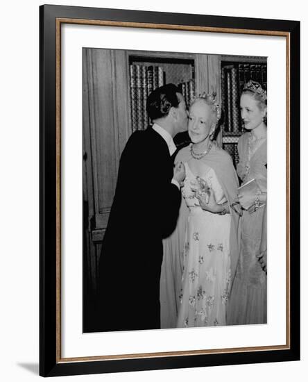 Famed Interior Decorator Lady Mendl Being Kissed by Oliver Messel at the British Embassy-William Vandivert-Framed Premium Photographic Print