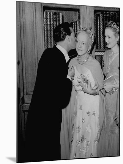 Famed Interior Decorator Lady Mendl Being Kissed by Oliver Messel at the British Embassy-William Vandivert-Mounted Premium Photographic Print