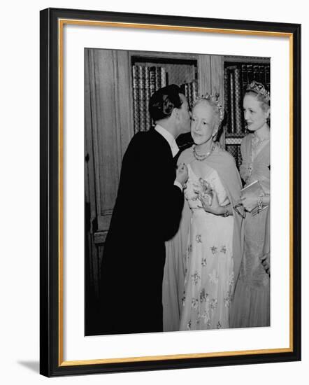 Famed Interior Decorator Lady Mendl Being Kissed by Oliver Messel at the British Embassy-William Vandivert-Framed Premium Photographic Print