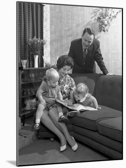 Family Group Looking at a Brochure, Doncaster, South Yorkshire, 1963-Michael Walters-Mounted Photographic Print