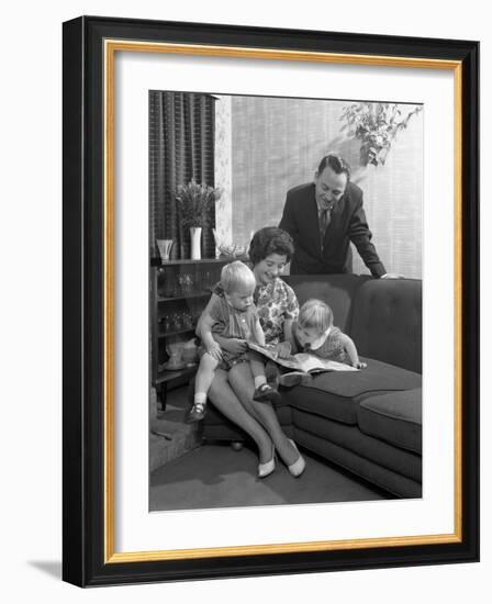 Family Group Looking at a Brochure, Doncaster, South Yorkshire, 1963-Michael Walters-Framed Photographic Print