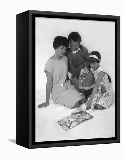Family Group Looking at a Magazine, 1963-Michael Walters-Framed Premier Image Canvas