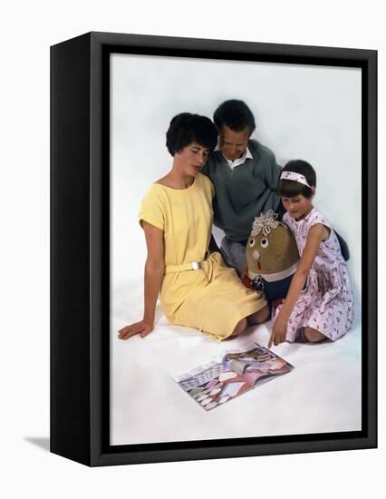 Family Group Looking at a Magazine, 1963-Michael Walters-Framed Premier Image Canvas