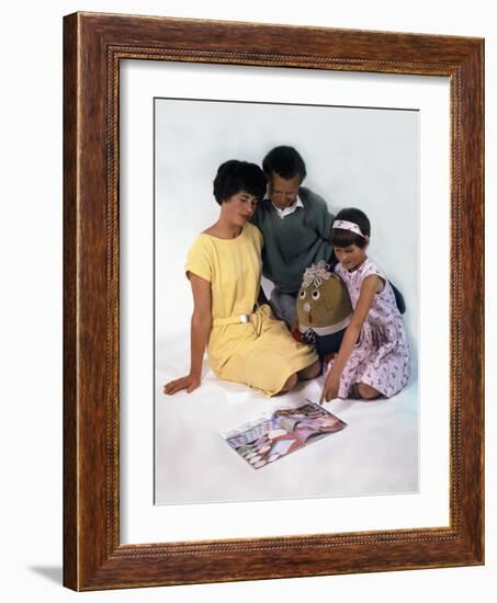 Family Group Looking at a Magazine, 1963-Michael Walters-Framed Photographic Print