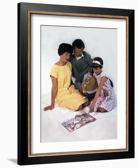 Family Group Looking at a Magazine, 1963-Michael Walters-Framed Photographic Print