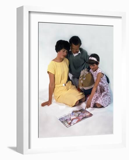 Family Group Looking at a Magazine, 1963-Michael Walters-Framed Photographic Print