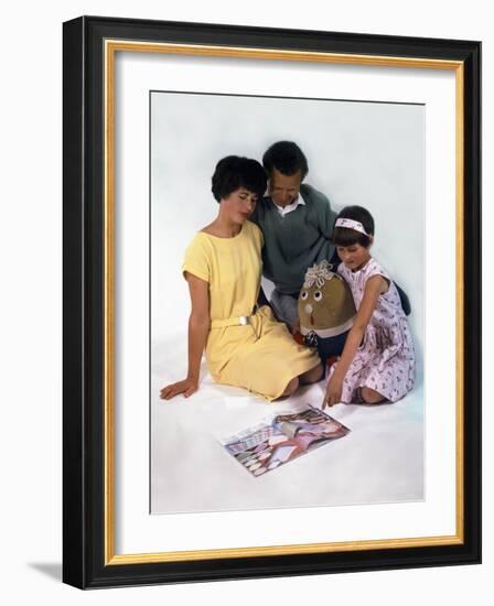 Family Group Looking at a Magazine, 1963-Michael Walters-Framed Photographic Print