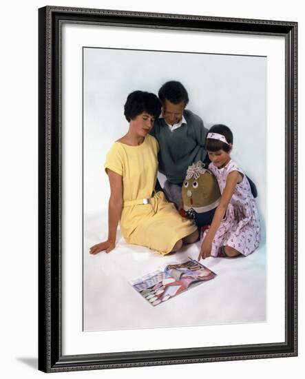 Family Group Looking at a Magazine, 1963-Michael Walters-Framed Photographic Print