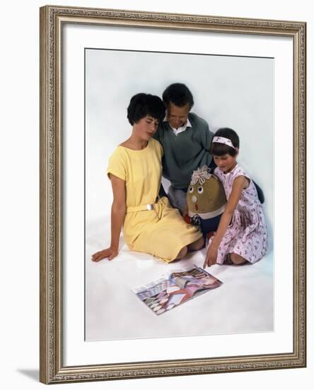 Family Group Looking at a Magazine, 1963-Michael Walters-Framed Photographic Print