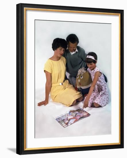 Family Group Looking at a Magazine, 1963-Michael Walters-Framed Photographic Print