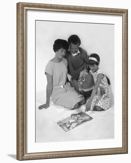 Family Group Looking at a Magazine, 1963-Michael Walters-Framed Photographic Print