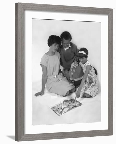 Family Group Looking at a Magazine, 1963-Michael Walters-Framed Photographic Print