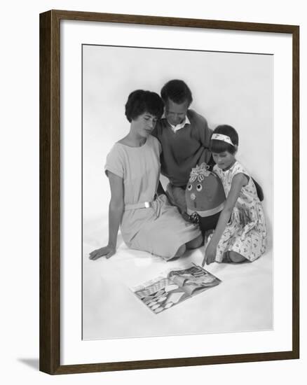 Family Group Looking at a Magazine, 1963-Michael Walters-Framed Photographic Print