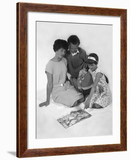 Family Group Looking at a Magazine, 1963-Michael Walters-Framed Photographic Print