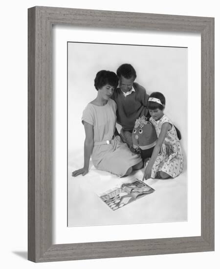 Family Group Looking at a Magazine, 1963-Michael Walters-Framed Photographic Print