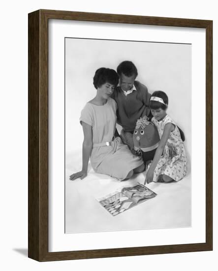 Family Group Looking at a Magazine, 1963-Michael Walters-Framed Photographic Print